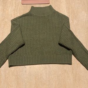 Divided crop green sweater in good condition. Size XS